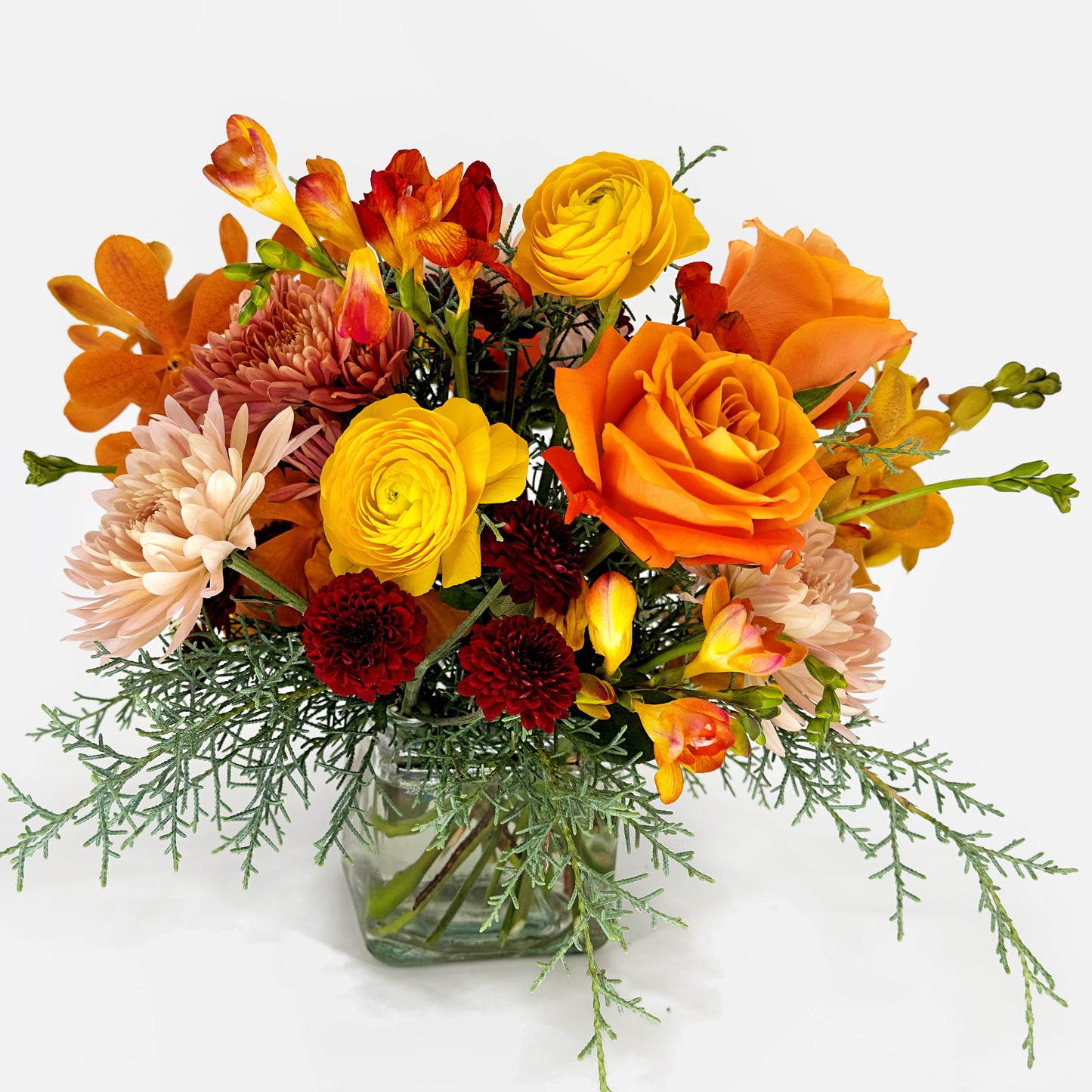Small flower arrangement with fresia, ranunculus, roses and orchids from Artichokes & Pomegranates Floral Design. Order online for delivery or pickup in Santa Fe.