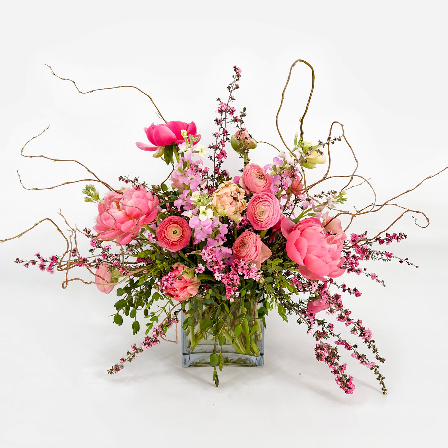 Large flower arrangement with peonies, ranunculus, tulips and curly willow from Artichokes & Pomegranates Floral Design. Order online for delivery or pickup in Santa Fe.