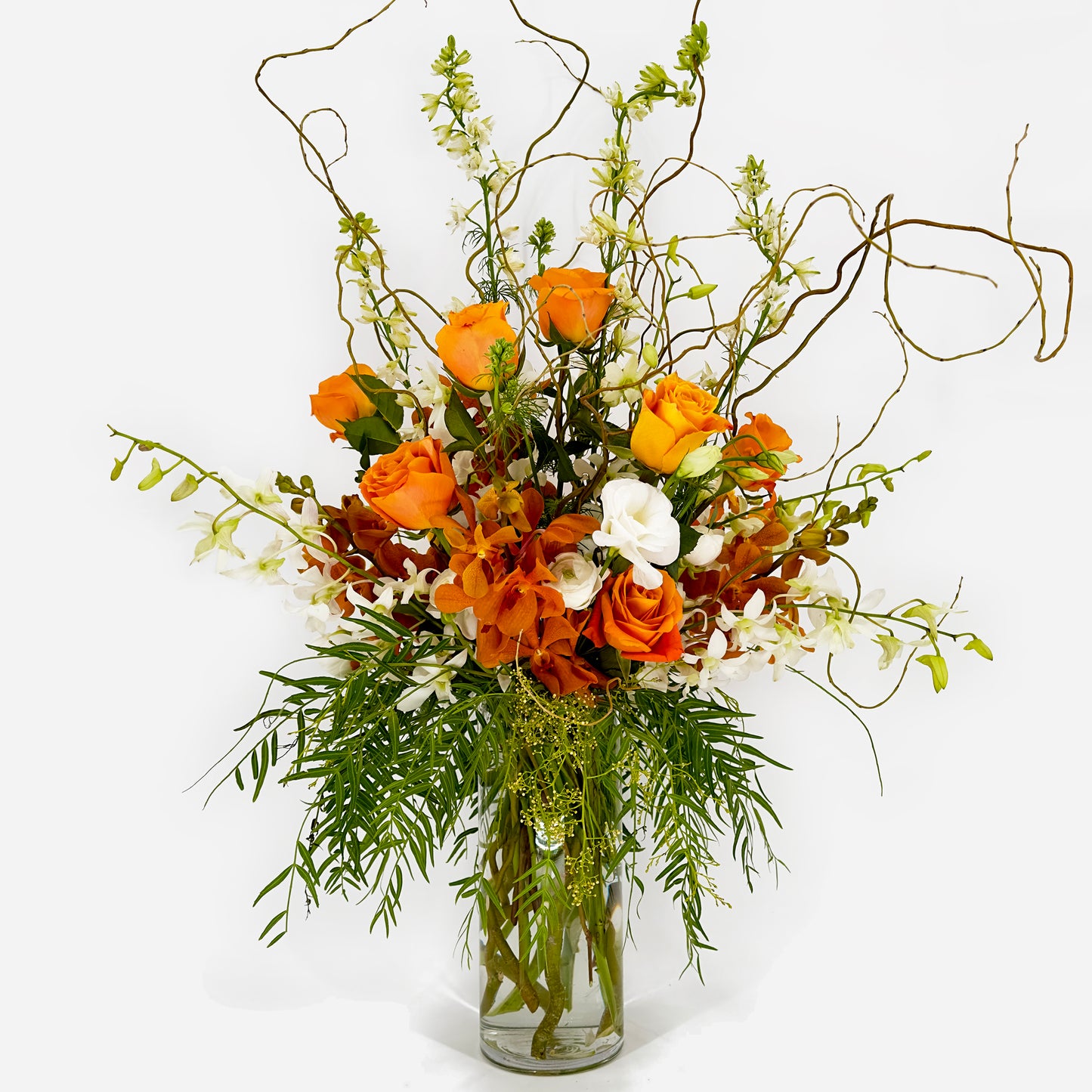 Large flower arrangement with roses, larkspur, orchids and curly willow from Artichokes & Pomegranates Floral Design. Order online for delivery or pickup in Santa Fe.