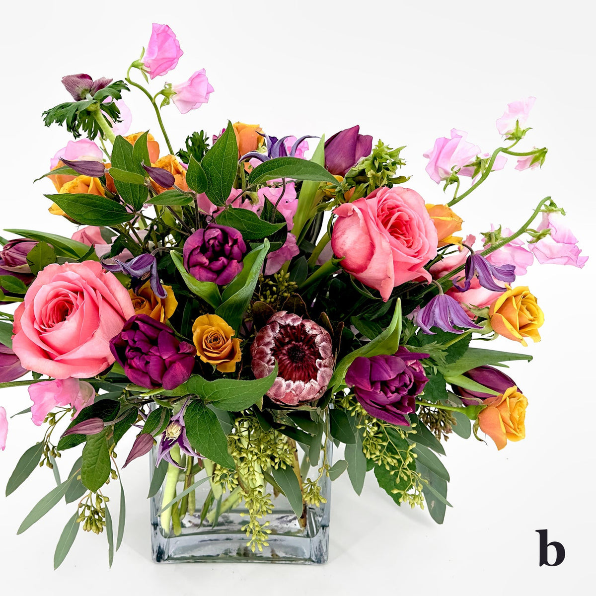 Large Low Flower Design from Artichokes and Pomegranates in Pinks, Purples and Golds