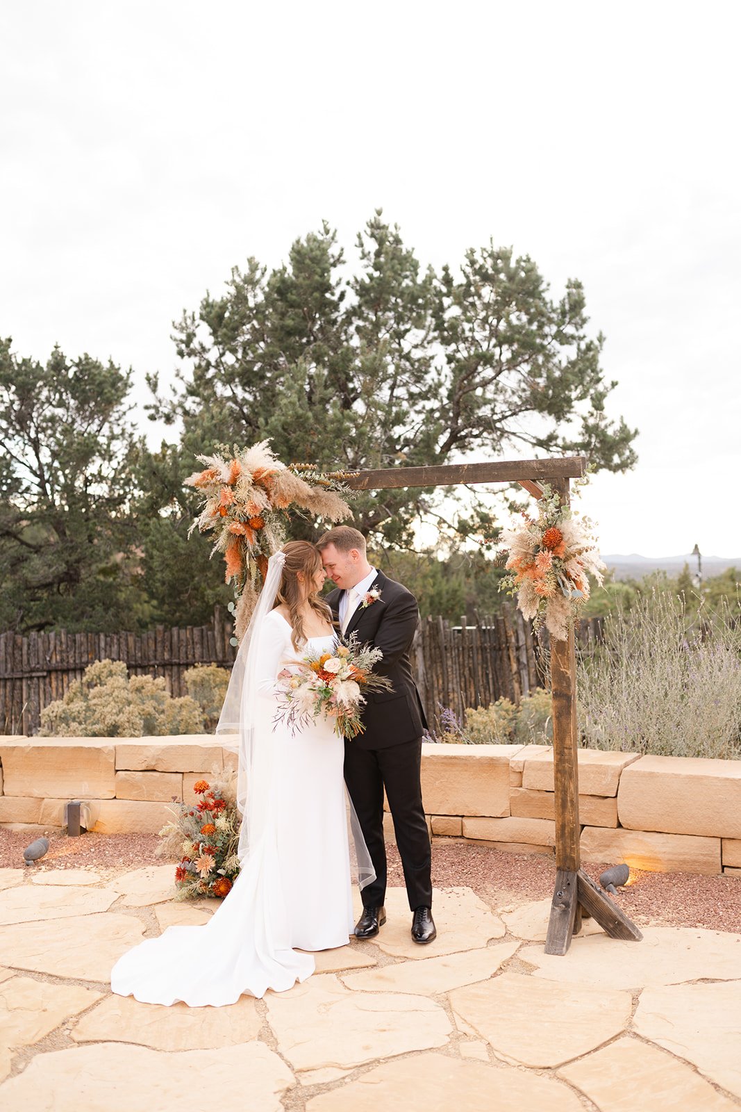 Artichokes & Pomegranates bridal bouquet, wedding ceremony flowers and arch in Santa Fe